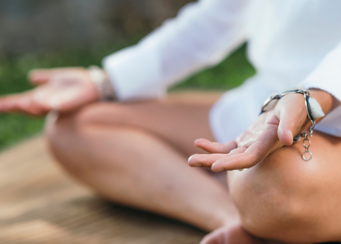 Hands resting in a meditation pose
